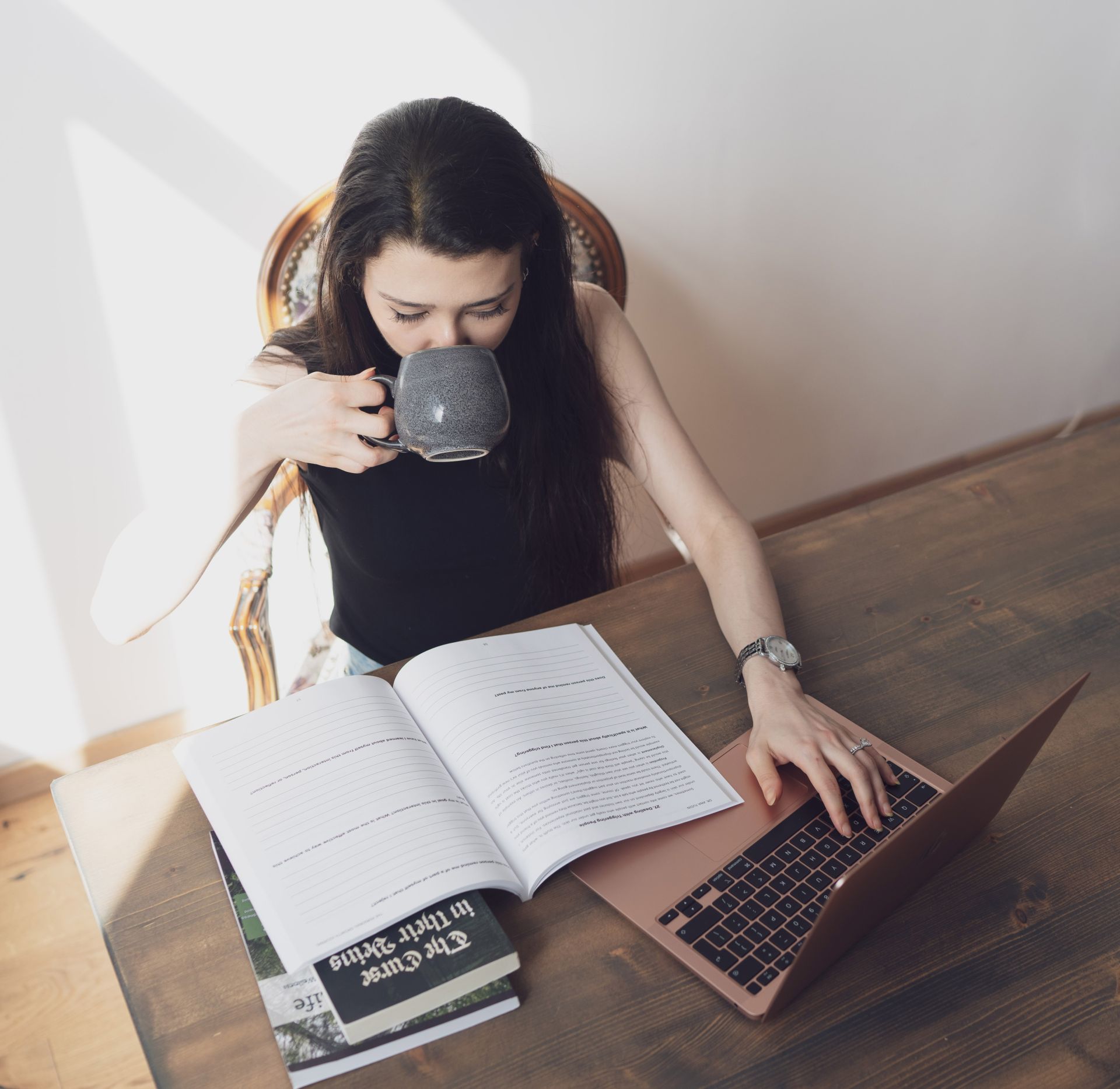 Woman studying with a laptop and coffee